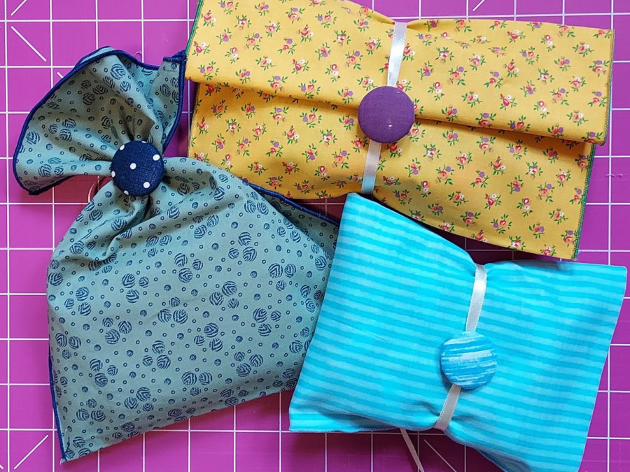 Reusable cloth fabric gift bags in bright colours with hand-covered buttons