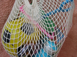 organic cotton string bag holding picnic items